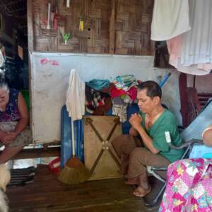 Chaplain praying for leprosy village couple