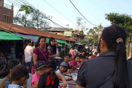 Sharing Christmas meal in Yangon neighborhood