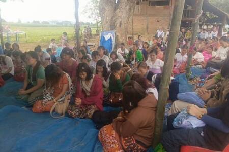 Praying during Christmas service Karen State