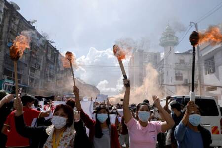 A group of women hold torches as they protest against the military coup in Yangon, Myanmar July 14, 2021. REUTERS/Stringer