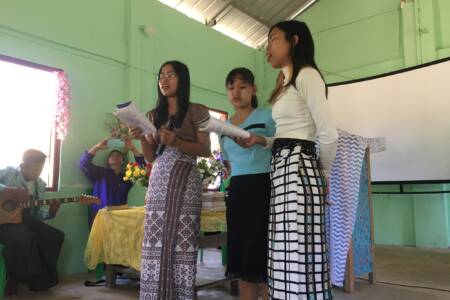 Young ladies singing at church service