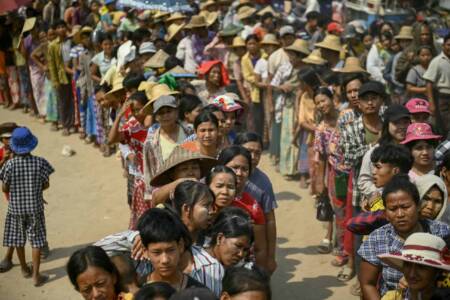 People line up for food aid being distributed in Sagaing on April 3, 2025, following the March 28 earthquake. The shallow 7.7-magnitude earthquake on March 28 flattened buildings across Myanmar, killing nearly 3,000 people and making thousands more homeless. (Photo by Sai Aung MAIN / AFP)