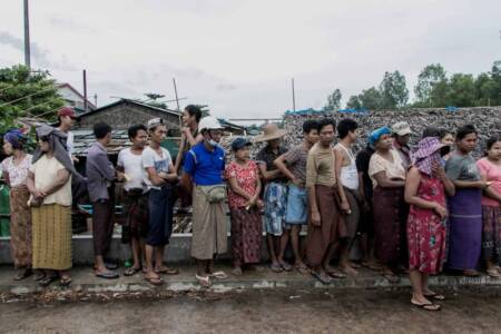 Food line People wait to receive bags of rice distributed by the World Food Programme as part of food aid efforts to support poor communities in the outskirts of Yangon on May 21, 2021. (AFP)